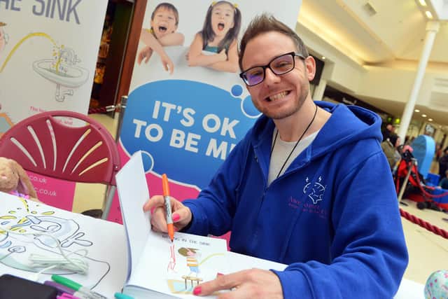 Richie Smith signing copies of his book in the Bridges Shopping Centre, Sunderland.