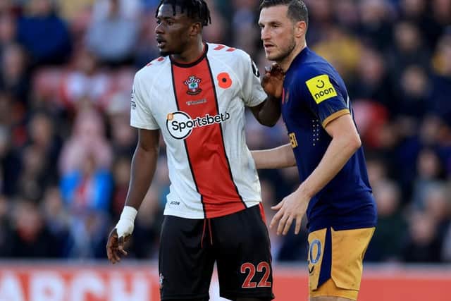 Chris Wood of United shadows Mohammed Salisu of Southampton during the Premier League match between Southampton FC and Newcastle United at Friends Provident St. Mary's Stadium on November 06, 2022 in Southampton, England. (Photo by David Cannon/Getty Images)