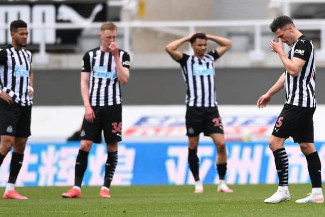 Newcastle United's Swiss defender Fabian Schar (R) walks off the pitch after being shown a red card during the English Premier League football match between Newcastle United and Arsenal at St James' Park in Newcastle-upon-Tyne, north east England on May 2, 2021.