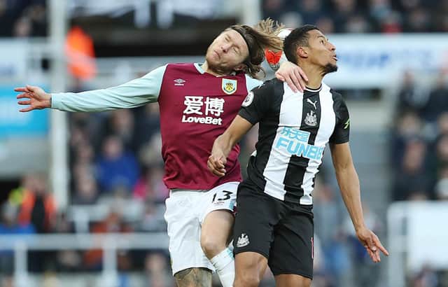 NEWCASTLE UPON TYNE, ENGLAND - FEBRUARY 29: Jamaal Lascelles of Newcastle United vies with Jeff Hendrick of Burnley during the Premier League match between Newcastle United and Burnley FC at St. James Park on February 29, 2020 in Newcastle upon Tyne, United Kingdom. (Photo by Ian MacNicol/Getty Images)