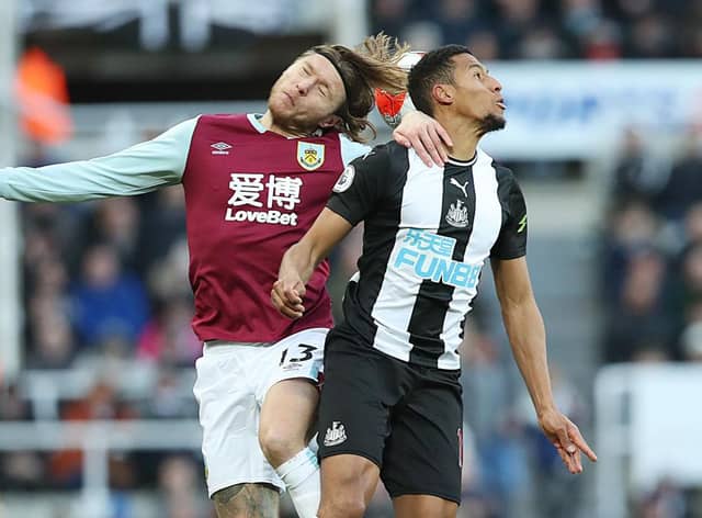 NEWCASTLE UPON TYNE, ENGLAND - FEBRUARY 29: Jamaal Lascelles of Newcastle United vies with Jeff Hendrick of Burnley during the Premier League match between Newcastle United and Burnley FC at St. James Park on February 29, 2020 in Newcastle upon Tyne, United Kingdom. (Photo by Ian MacNicol/Getty Images)