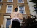A protester holds a sign up outside the home of Prime Minister Boris Johnson's senior aide Dominic Cummings in north London. Picture: PA.