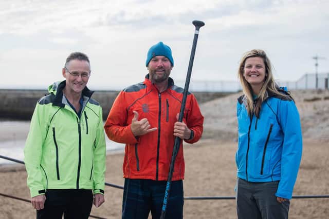 Brendon Prince (centre) at Seaham Harbour with Fraser Ranson and Emma Nichol of local company Showers Pass UK
