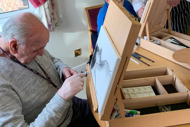 Chef Alan Bulmer with residents as he holds art classes at the home.
