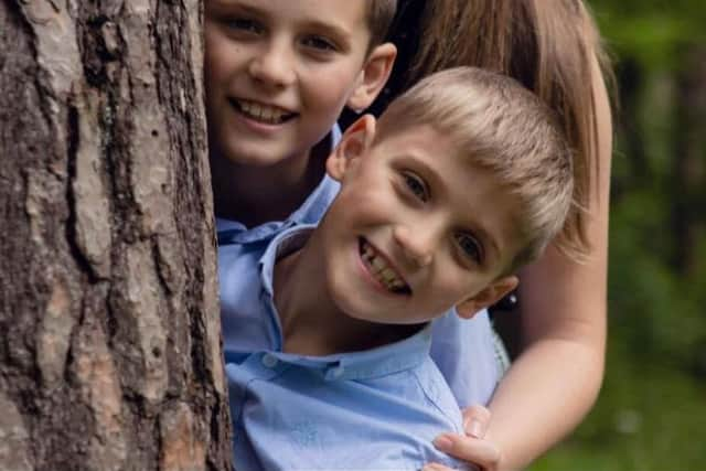 Ethan Adams, eight, with his sister Ellie, 14, and brother Evan, 11.