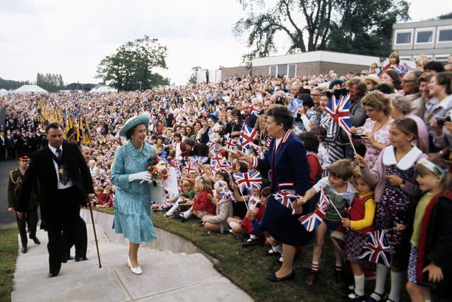 Queen Elizabeth II being greeted by a huge crowd on a sports field at Butterley Hall, near Chesterfield, during her Silver Jubilee tour of Great Britain. 28/07/77