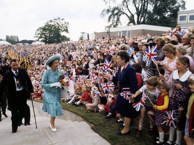 Queen Elizabeth II being greeted by a huge crowd on a sports field at Butterley Hall, near Chesterfield, during her Silver Jubilee tour of Great Britain. 28/07/77