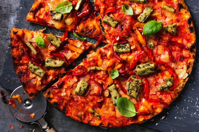 'Delicious stonebaked pizza, topped with a signature tomato sauce, vegan herb chicken and grilled peppers'