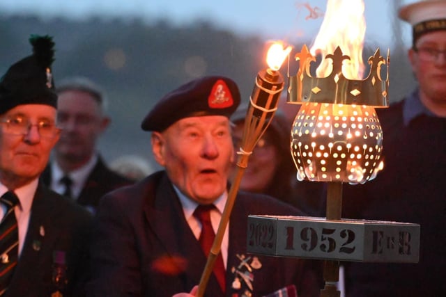 90-year-old Korean Army veteran Joseph Smith Bailes lights the first beacon.
