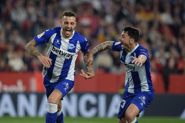 Alaves' Spanish forward Joselu (L) celebrates with Alaves' Spanish defender Ximo Navarro after scoring a goal during the Spanish league football match between Sevilla FC and Deportivo Alaves at the Ramon Sanchez Pizjuan stadium in Seville on February 2, 2020.