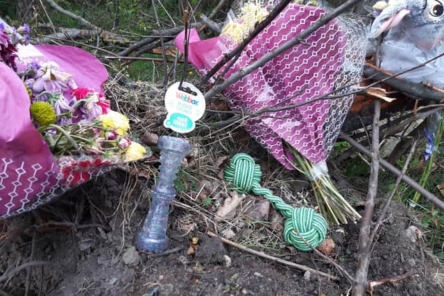 Flowers and dog toys have been among the items left at the collision scene.