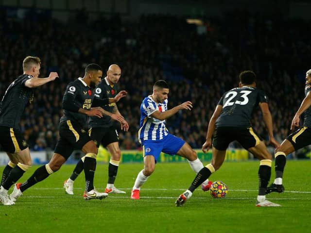 Neal Maupay of Brighton & Hove Albion runs with the ball from Jacob Murphy and Joelinton of Newcastle United during the Premier League match between Brighton & Hove Albion and Newcastle United. (Photo by Charlie Crowhurst/Getty Images)
