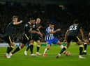 Neal Maupay of Brighton & Hove Albion runs with the ball from Jacob Murphy and Joelinton of Newcastle United during the Premier League match between Brighton & Hove Albion and Newcastle United. (Photo by Charlie Crowhurst/Getty Images)