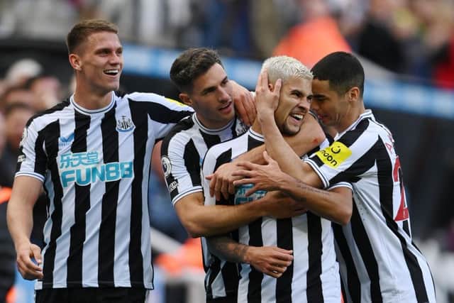 Bruno Guimaraes of Newcastle United celebrates with teammates after scoring their team's third goal during the Premier League match between Newcastle United and Brentford FC at St. James Park on October 08, 2022 in Newcastle upon Tyne, England. (Photo by Stu Forster/Getty Images)