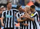 Bruno Guimaraes of Newcastle United celebrates with teammates after scoring their team's third goal during the Premier League match between Newcastle United and Brentford FC at St. James Park on October 08, 2022 in Newcastle upon Tyne, England. (Photo by Stu Forster/Getty Images)