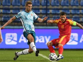 Norway's Kristoffer Ajer (L) fights for the ball with Montenegro's Stevan Jovetic (R) during the FIFA World Cup Qatar 2022 qualification Group G football match between Montenegro and Norway at the Podgorica City Stadium, in Podgorica, on March 30, 2021.