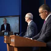 Prime Minister Boris Johnson appears on a screen from Chequers, where he is self-isolating, while chief scientific adviser Sir Patrick Vallance and deputy chief medical officer for England Professor Jonathan Van Tam speak from Downing Street, during a coronavirus briefing. Picture  by PA.