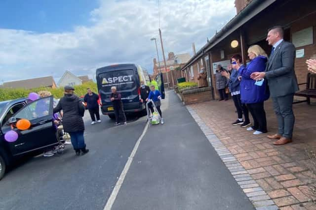 Health workers cheers as Jannette returns home.