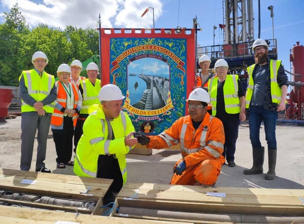 Cllr Ernest Gibson is presented with a piece of coal from St Hilda's mine from site manager Lionel Jones, as Cllr Margaret Meling looks on alongside members of Harton and Westoe Miners Banner Group.
