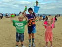 Crowds gather at Sandhaven Beach during the heatwave with youngsters Carter Nicholson, four, Jake Flaherty, eight and Isabell Nicholson, two