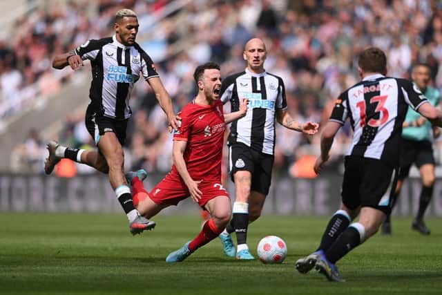 Liverpool striker Diogo Jota is fouled by Newcastle player Joelinton during the Premier League match between Newcastle United and Liverpool at St. James Park on April 30, 2022 in Newcastle upon Tyne, England. (Photo by Stu Forster/Getty Images)