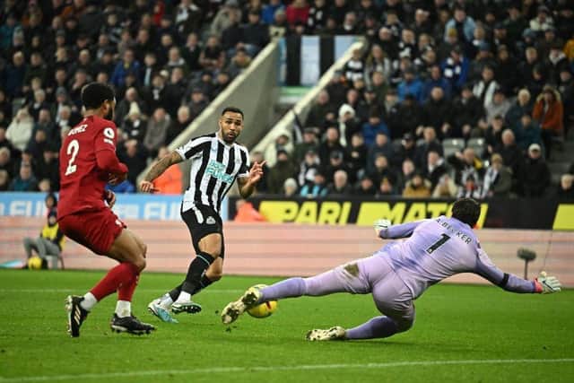 Newcastle United's English striker Callum Wilson shoots the ball but Liverpool's Brazilian goalkeeper Alisson Becker (R) stops the ball during the English Premier League football match between Newcastle United and Liverpool at St James' Park in Newcastle-upon-Tyne, north east England on February 18, 2023. (Photo by OLI SCARFF/AFP via Getty Images)