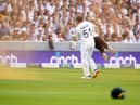 England's Johnny Bairstow carrying a Just Stop Oil protestor off the pitch  during day one of the second Ashes test match at Lord's, London. Adam Davy/PA Wire.