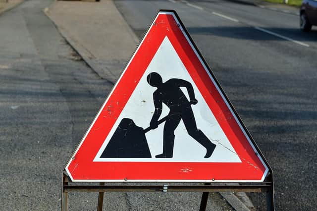 Stock image of a men at work sign