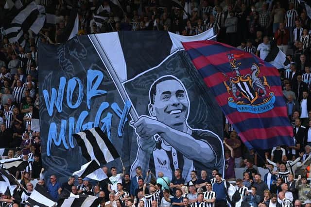 Newcastle United's Miguel Almiron is featured on a Wor Flags banner.