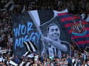 Newcastle United's Miguel Almiron is featured on a Wor Flags banner.