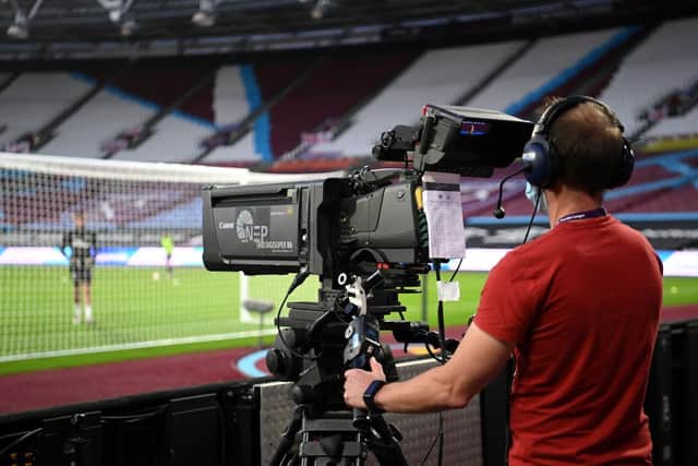 A TV Camera man films the warm-up prior to the Premier League match between West Ham United and Newcastle United at the London Stadium.