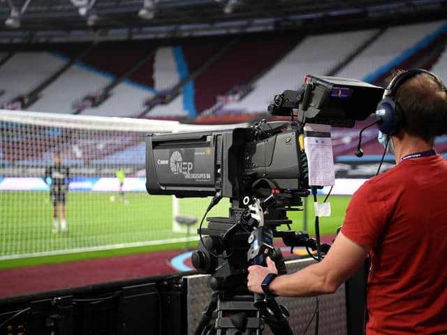 A TV Camera man films the warm-up prior to the Premier League match between West Ham United and Newcastle United at the London Stadium.