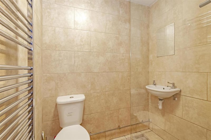 Fully tiled ensuite shower room with walk-in shower area/electric shower. Wash hand basin and low-level WC. Chrome, heated towel rail.