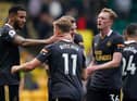 Newcastle United's Jamaal Lascelles, Matt Ritchie, Emil Krafth and Sean Longstaff celebrate the club's win at Carrow Road.