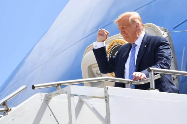US President Donald Trump gestures as he walks off Air Force One on July 29, 2020 upon arrival at Midland Airport in Midland, Texas. (Photo by Nicholas Kamm / AFP) (Photo by NICHOLAS KAMM/AFP via Getty Images)