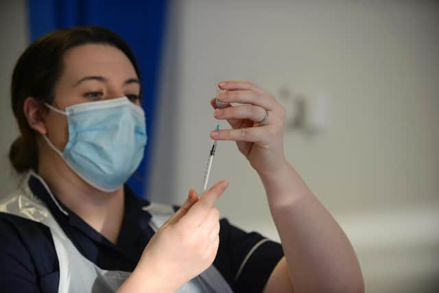 A health worker prepares to administer the Covid-19 vaccine