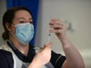 A health worker prepares to administer the Covid-19 vaccine