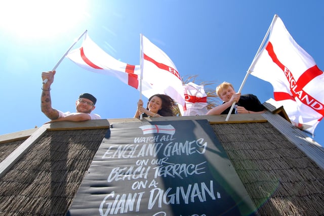 A giant outside digital screeb and flags galore at The Rattler. Pictured are Paul Freeman, Natalie Peters and Liam Robson.