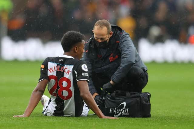 Joe Willock of Newcastle United receives medical treatment during the Premier League match between Wolverhampton Wanderers and Newcastle United  (Photo by Catherine Ivill/Getty Images)