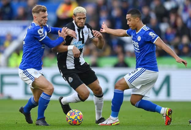 Joelinton of Newcastle United battles for possession with Kiernan Dewsbury-Hall and Youri Tielemans of Leicester City during the Premier League match between Leicester City and Newcastle United at The King Power Stadium on December 12, 2021 in Leicester, England. (Photo by Gareth Copley/Getty Images)