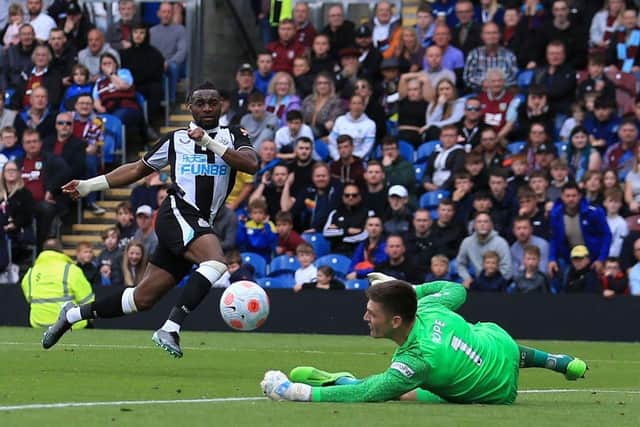 Newcastle United's French midfielder Allan Saint-Maximin (L) has an unsuccessful shot past Burnley's English goalkeeper Nick Pope (R) during the English Premier League football match between Burnley and Newcastle United at Turf Moor in Burnley, north west England on May 22, 2022. (Photo by LINDSEY PARNABY/AFP via Getty Images)