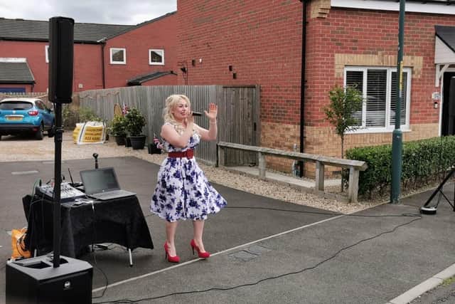 Singer Carly McKeith performs for residents in Gerald Street, Whiteleas on VE Day.
