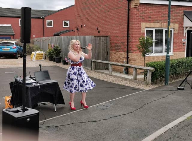 Singer Carly McKeith performs for residents in Gerald Street, Whiteleas on VE Day.