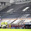 General view inside the empty stadium as the Newcastle United and West Ham United players line-up.