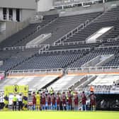 General view inside the empty stadium as the Newcastle United and West Ham United players line-up.