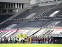 General view inside the empty stadium as the Newcastle United and West Ham United players line-up.