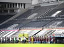 General view inside the empty stadium as the Newcastle United and West Ham United players line-up.