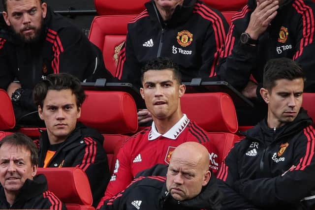 Manchester United's Portuguese striker Cristiano Ronaldo (C) reacts as he sits on the bench during the English Premier League football match between Manchester United and Newcastle at Old Trafford in Manchester, north west England, on October 16, 2022. (Photo by IAN HODGSON/AFP via Getty Images)