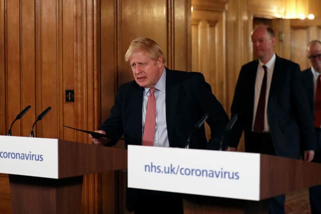 Prime Minister Boris Johnson arrives at a news conference inside 10 Downing Street. Picture: PA.