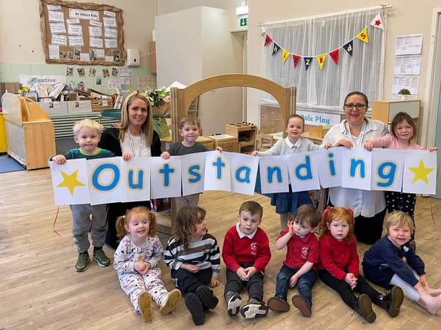 Deputy manager Hayley Rochford and manager Kathryn Pino celebrate the nursery's outstanding Ofsted with the children.